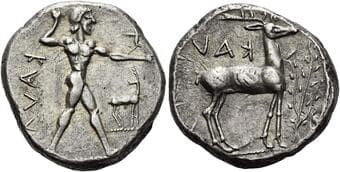Bruttium, Caulonia Nomos circa 475-425, AR 20 mm, 8.17 g. KAVΛ retrograde Apollo walking r., holding laurel branch and...