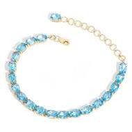 14ct Blue Topaz Line Bracelet One 14 carat yellow gold line bracelet holds 19 claw set 7.00x5.00 millimetre oval "sky"...