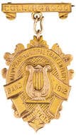 MALVN. PRAHN. MUNICIPAL TRAM EMPLOYS BAND, 1912, gVF 9ct fob medal in the form of elaborate shield with scrolls, with...