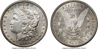 Morgan Dollars 1892-S $1 AU53 PCGS. The piece displays softer mercurial silver luster with light gold toning gently...